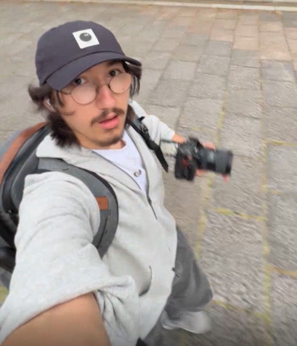 alex holding a camera